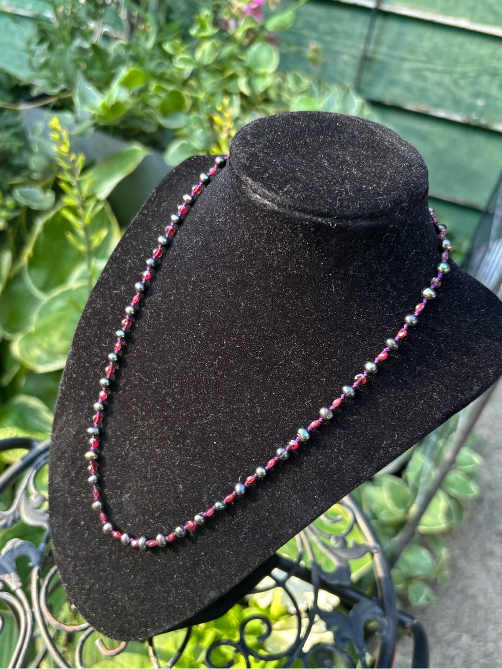 Real peacock pearl and garnet necklace.